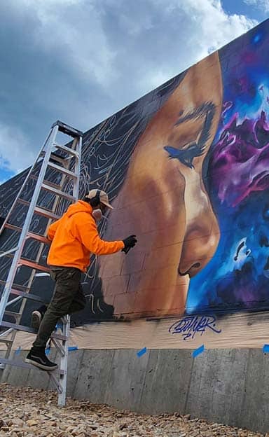 Ethereal Echoes artwork being painted by Bimmer Torres
